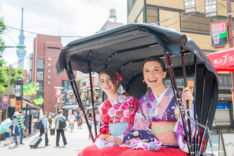 Visitors to Japan enjoying the rickshaw