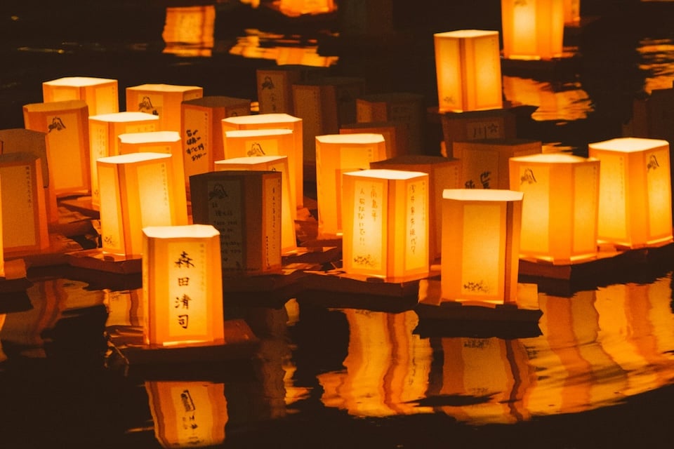ceremony in which paper lanterns are floated down a river